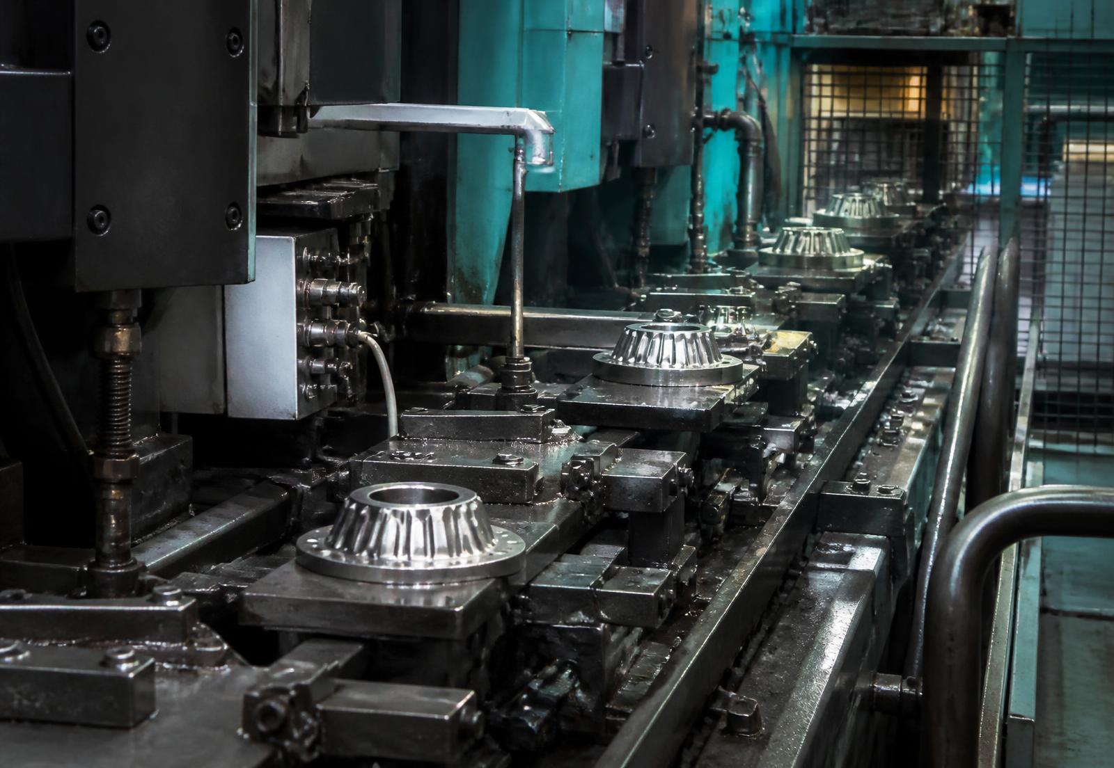 Machined components moving through production equipment